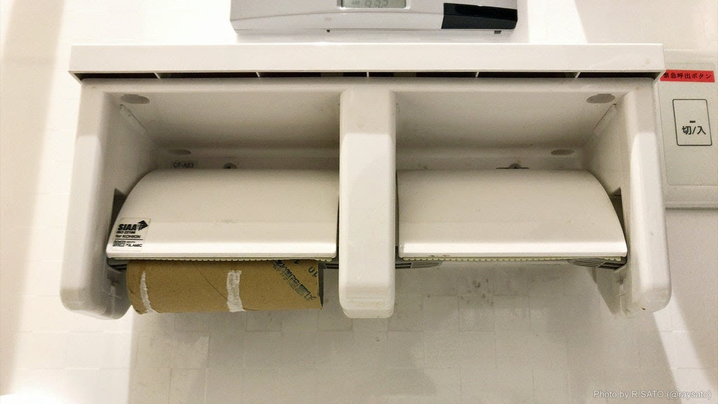 Two toilet paper holders side by side: one with an empty cardboard roll, the other with no roll at all